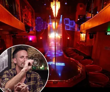 Cozy strip club interior with stage and circular inset of person sipping a drink.
