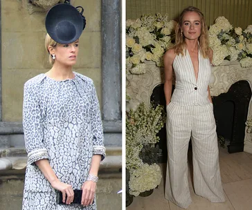 Two women in fashionable outfits; one in a patterned dress with a large hat, the other in a striped jumpsuit by floral decor.