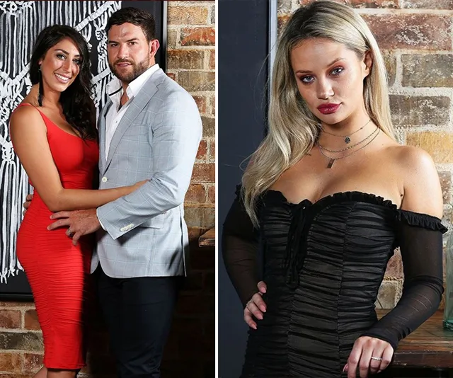Couple posing against a brick wall on the left, woman in red dress, man in light jacket. Blonde woman in black dress on right.