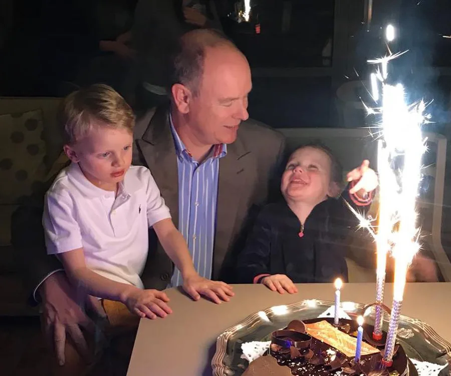 Prince Albert celebrates his children's birthday with cake and sparklers.