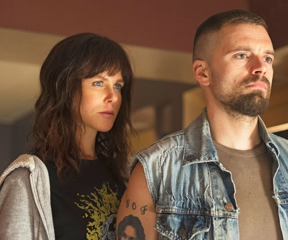 Nicole Kidman as Erin Bell in "Destroyer," standing intently beside a man with a denim vest and tattoo.