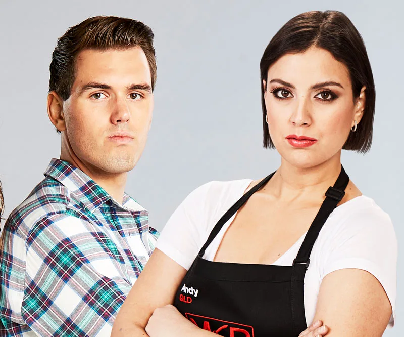 Male in plaid shirt and female in apron from "My Kitchen Rules" pose confidently against a plain background.