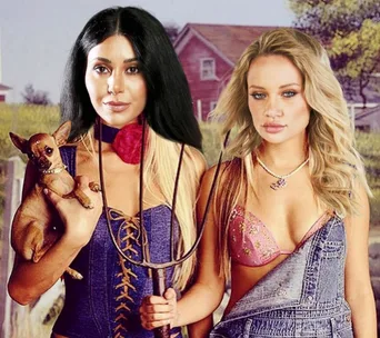 Two women in overalls; one holds a pitchfork and the other a small dog, in a rural setting.