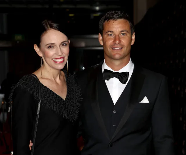 A man and woman in formal attire, smiling and posing together at an event.