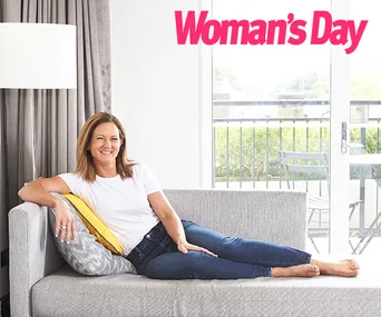 Woman in casual clothes relaxing on a couch with "Woman's Day" logo above.