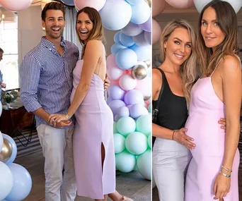 A pregnant woman in a lilac dress at a baby shower with balloons, posing with a man and another woman.