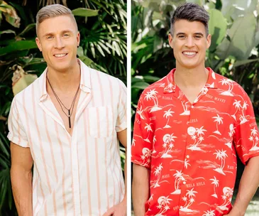 Two men smiling outdoors, one in a striped shirt, the other in a red tropical shirt, surrounded by green foliage.