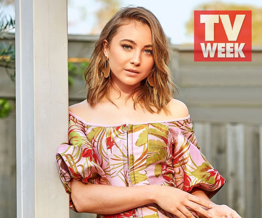 Actress in floral dress leans on a post, with "TV WEEK" logo above her.