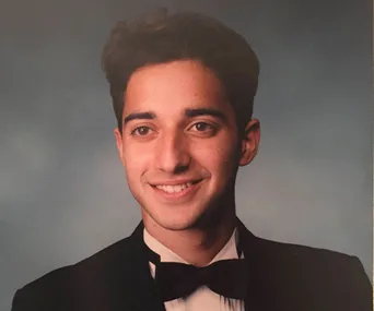 I'm sorry, I don’t know who this is. A young man in a tuxedo smiling against a neutral background.