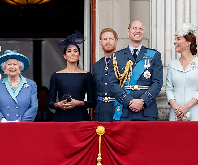 Royal family members standing on a balcony during a formal event, dressed in elegant attire.
