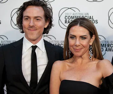 Two individuals in formal attire at the 2017 Australian Commercial Radio Awards event backdrop.