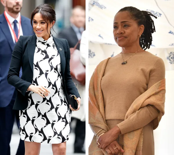 Two women, left in black and white dress smiling, right in brown outfit, standing and looking ahead.