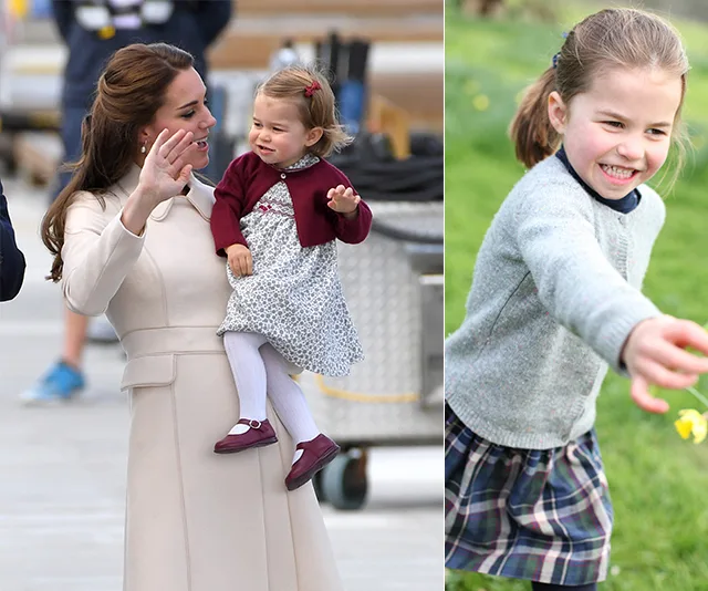 Young girl in a plaid skirt and grey sweater smiling in a garden; woman holding her as a toddler in a maroon cardigan.
