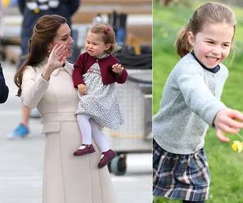 Young girl in a plaid skirt and grey sweater smiling in a garden; woman holding her as a toddler in a maroon cardigan.