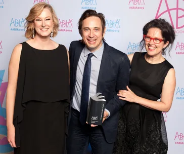 Three people smiling at the 2019 Australian Book Industry Awards, holding an award trophy.