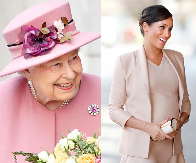 Two women smiling, one in a pink hat holding flowers, the other in a beige outfit holding a clutch.