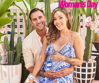 A couple smiling, the woman holding her baby bump, surrounded by potted cacti with "Woman's Day" logo in the corner.