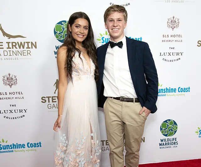 Two individuals smiling on the red carpet at the Steve Irwin Gala Dinner, with event branding in the background.