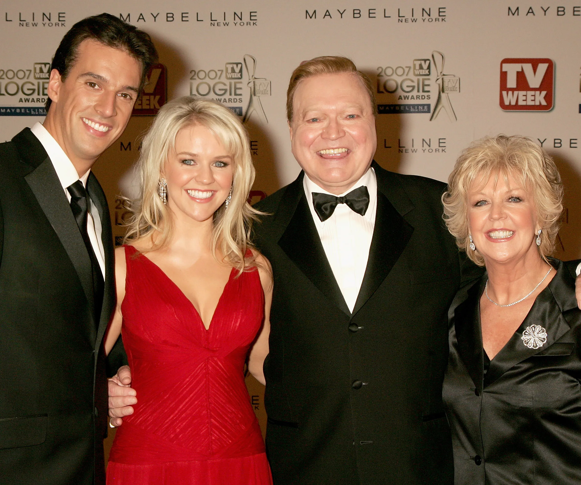Group posing at 2007 TV Week Logie Awards; man, woman in red dress, man in tux, woman in black dress.