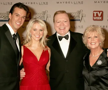 Group posing at 2007 TV Week Logie Awards; man, woman in red dress, man in tux, woman in black dress.