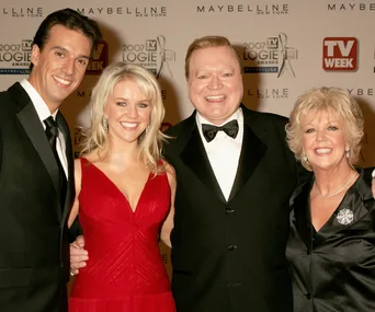 Group posing at 2007 TV Week Logie Awards; man, woman in red dress, man in tux, woman in black dress.