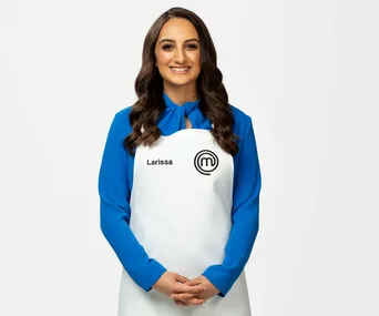 "Larissa in blue blouse and MasterChef apron, smiling with hands clasped."