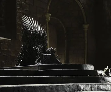 The Iron Throne from "Game of Thrones" in a dimly lit stone hall.