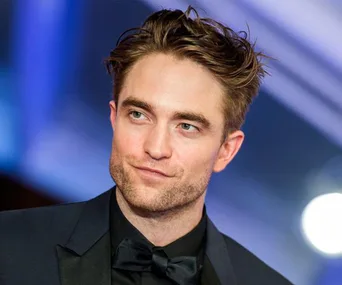 Actor in a suit at an event, associated with the role of Batman.