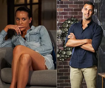 Couple from "Married at First Sight," woman in denim shirt on a couch, man in black shirt standing with arms crossed.