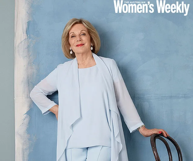 Woman in light blue suit leaning on a chair against a blue background, with "The Australian Women's Weekly" text above.