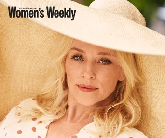 Blonde woman in wide-brimmed hat, wearing a polka dot blouse, featured in The Australian Women's Weekly.