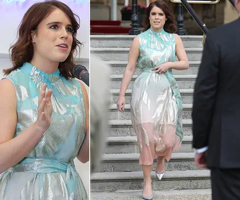 Princess Eugenie in a sleeveless blue and silver dress, speaking at an event and walking down stairs.