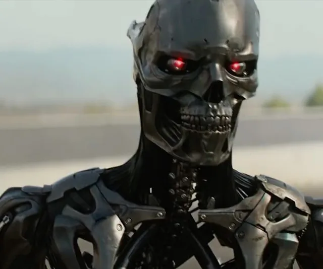 A robotic endoskeleton with glowing red eyes from "Terminator: Dark Fate."