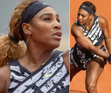 Serena Williams in black and white Nike outfit during French Open, focused on the court.