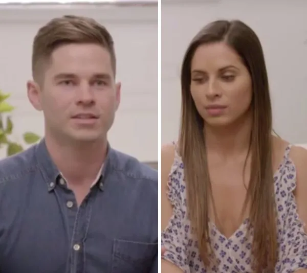 Man in a blue shirt and woman in a floral dress from "The Super Switch" are sitting and talking indoors.