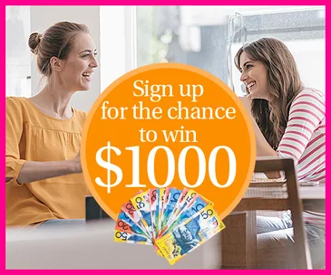 Two women chatting at a café with a chance to win $1000 sign and colorful currency displayed prominently.