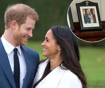 Engaged couple smiling at each other outdoors, with an inset of their framed photo on display.