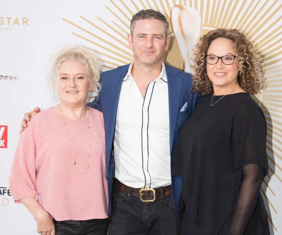 Three people at the Logie Awards nominations event, standing together and smiling for the camera.