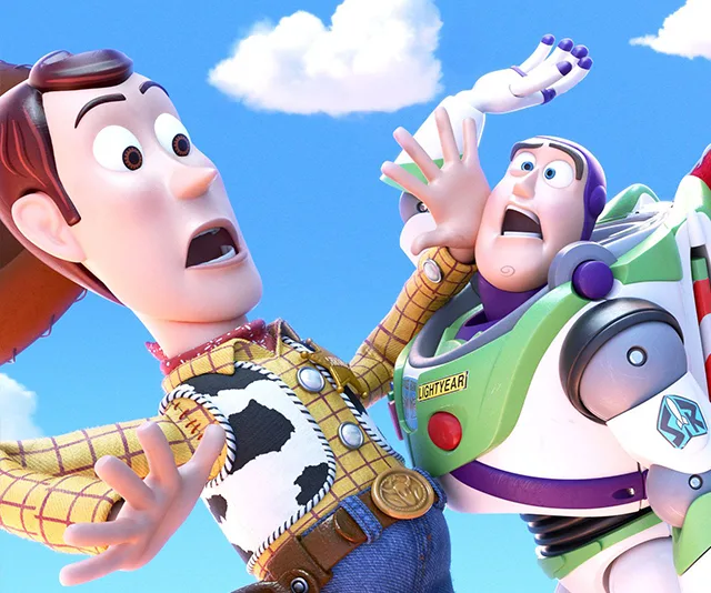 Woody and Buzz Lightyear from Toy Story 4 look surprised against a bright blue sky with clouds.