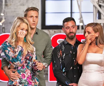 Two couples standing with the women wiping tears, all showing emotional expressions in an interior setting.