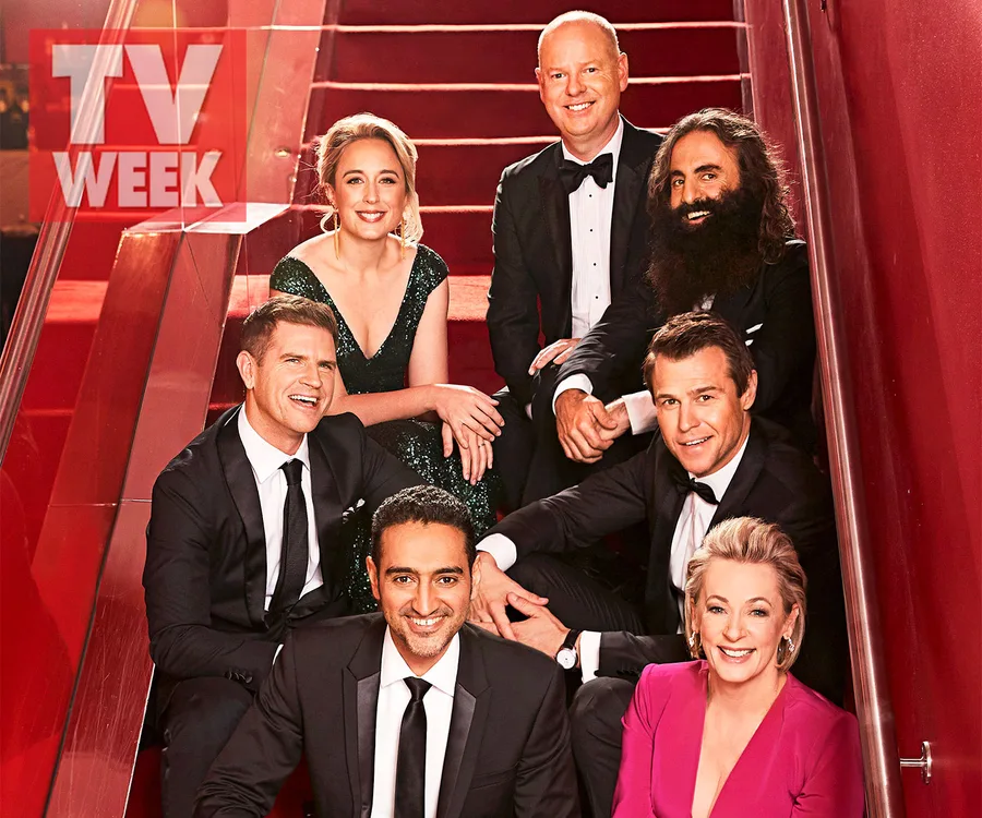 Group of seven people in formal attire sitting on stairs with a "TV WEEK" logo.