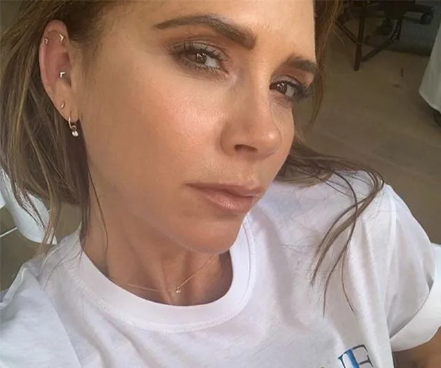 Victoria Beckham wearing a white Pride T-shirt, close-up selfie indoors.