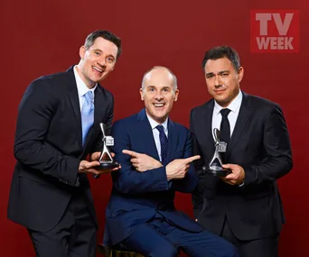 Three men in suits smiling and holding TV Week Logie awards against a red background.