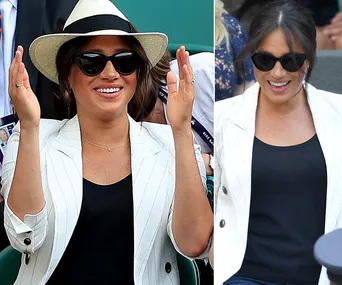 Woman in white blazer and sunglasses enjoying a tennis match.