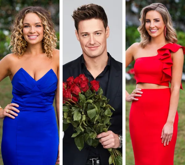 Three people smiling; the person in the center holds red roses. The other two wear blue and red dresses respectively.