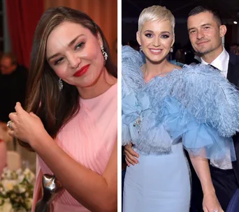 Miranda Kerr in a pink dress and Katy Perry with Orlando Bloom in blue attire at an event.