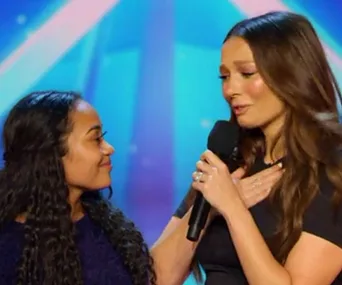 Ricki-Lee Coulter celebrates emotional moment with a young contestant on Australia's Got Talent stage.