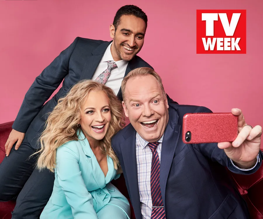 Three people in suits take a selfie against a pink background with a "TV Week" logo in the top right corner.