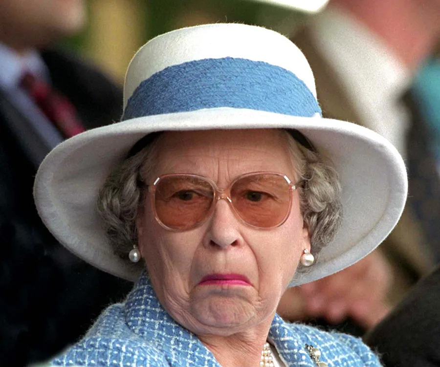 A person in a white hat and sunglasses making a surprised expression.