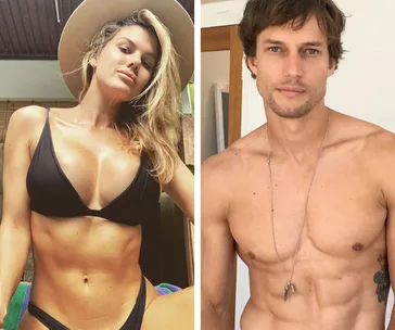 Two individuals posing in swimwear; the woman wears a black bikini and hat, the man is shirtless with a necklace.